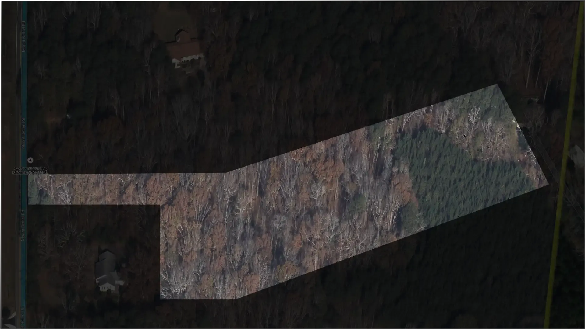 Aerial view of the 5.84-acre wooded property
